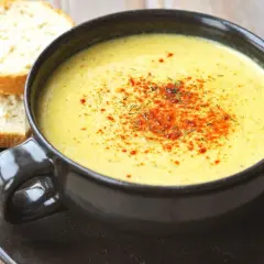 Aksamitna zupa z serków topionych, posypana papryką i ziołami, podana z chrupiącym pieczywem.