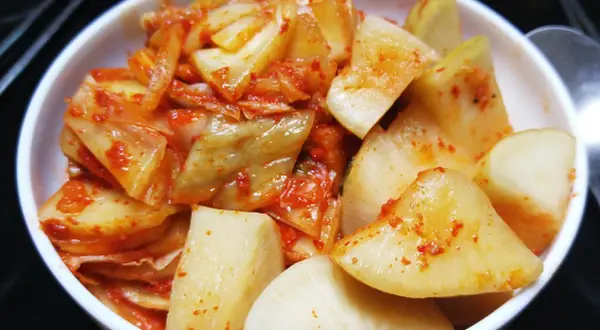 Pikantne kimchi w białej misce. Zastanawiasz się, jak długo przechowywać kimchi? To danie jest gotowe do spożycia!