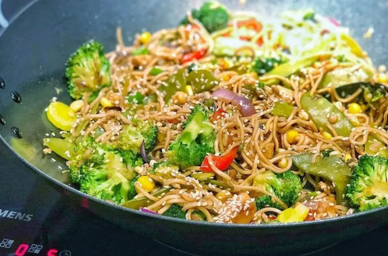 Makaron chow mein zrobiony z pszenicy, z brokułami, papryką, kukurydzą i sezamem.