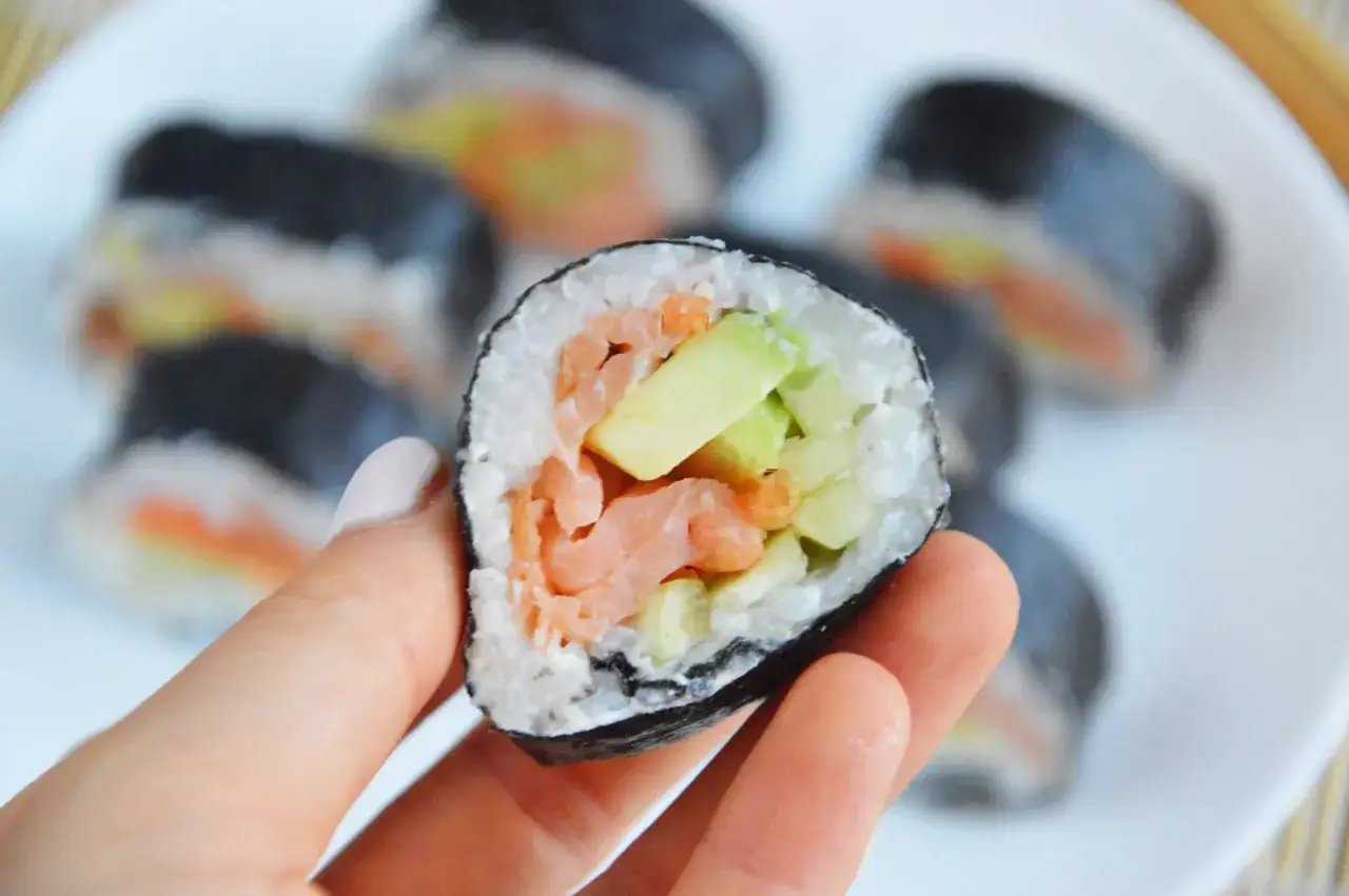 Rolka sushi z łososiem i awokado, idealna do zrobienia sushi w domu.