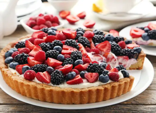 Pyszna tarta z mascarpone i bogactwem świeżych owoców: truskawek, malin, jeżyn i borówek. Idealna na letnie popołudnie.