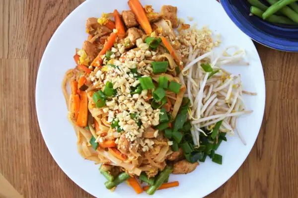 Pad Thai z kurczakiem, warzywami i posiekanymi orzeszkami ziemnymi. Idealne jakie orzechy do pad thai.